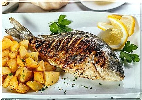 Delicious roasted sea bass with potatoes and onions