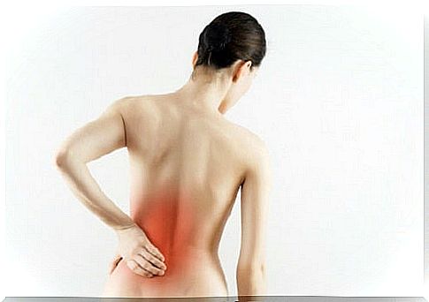 woman with pain in the lower back due to herniated disc