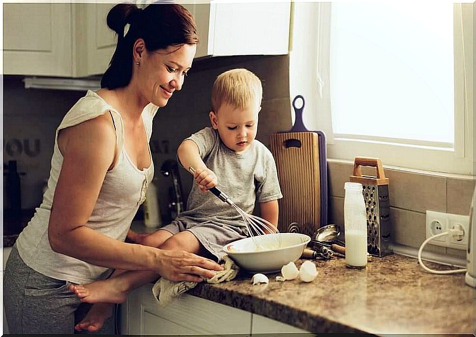 Mother teaching child with learning problems to cook